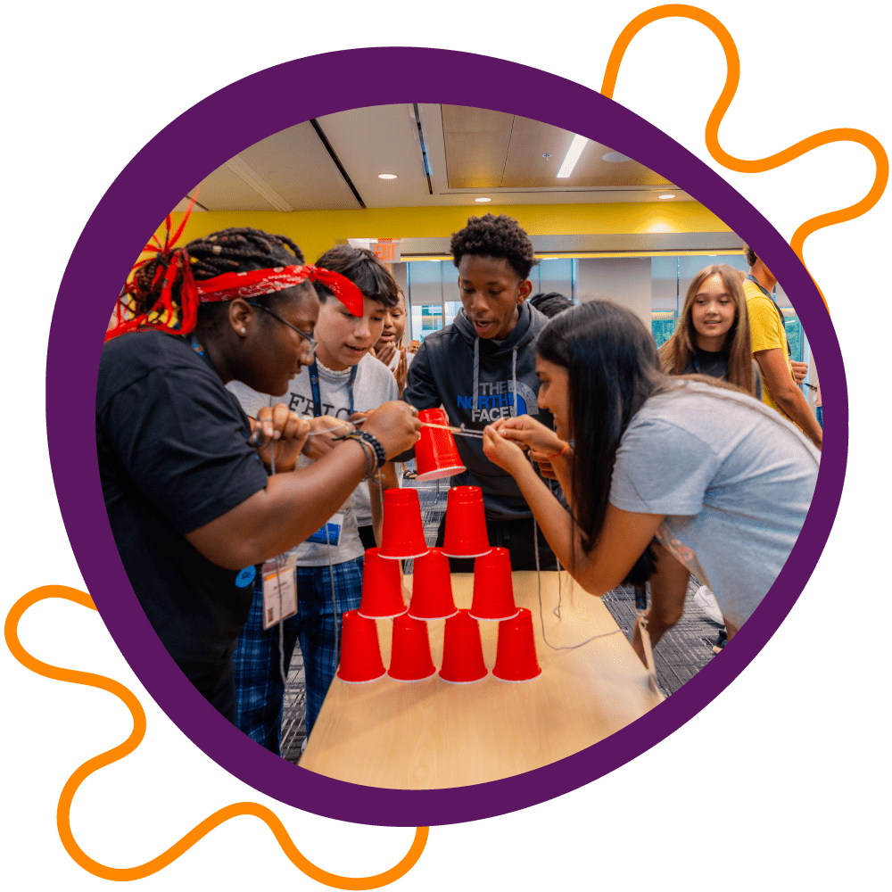 Youth participate in a cup-stacking icebreaker.